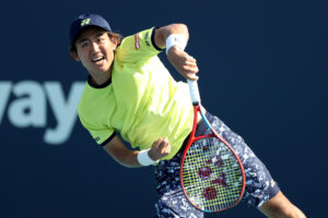 MIAMI GARDENS, FLORIDA - MARCH 28: Yoshihito Nishioka of Japan returns a shot to Lloyd Harris of South Africa during the Men's Singles match on Day 8 of the 2022 Miami Open presented by Itaú at at Hard Rock Stadium on March 28, 2022 in Miami Gardens, Florida. (Photo by Megan Briggs/Getty Images)